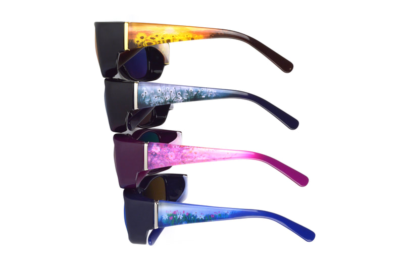 Four pairs of Fits Over sunglasses in different colorways featuring painterly illustrations of flowers printed on the temple.